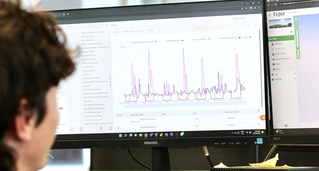 Expert solar analyst reviewing statistical data on a computer screen